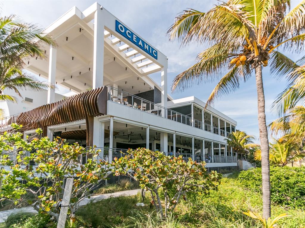 750 North Ocean Boulevard, Unit 210 Pompano Beach, FL 33062 - Photo 20 of 57 a front view of a building with a garden