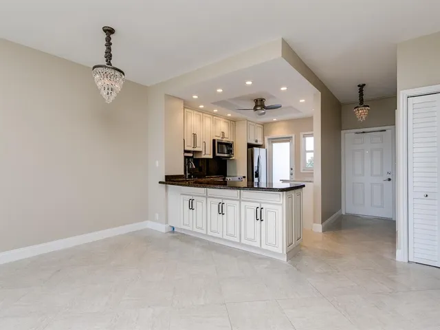 a view of kitchen with center island and stainless steel appliances