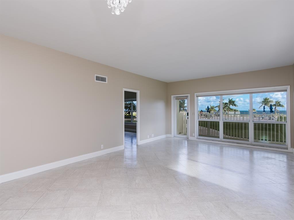 750 North Ocean Boulevard, Unit 210 Pompano Beach, FL 33062 - Photo 6 of 57 an empty room with floor to ceiling window and an outdoor view