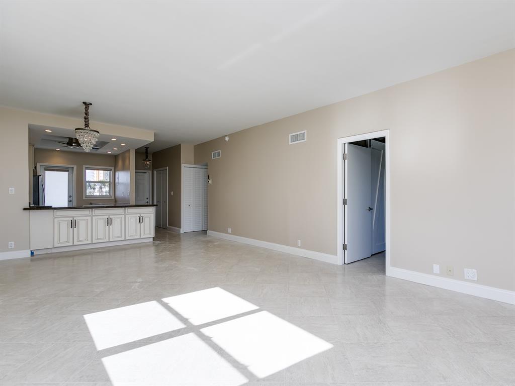 750 North Ocean Boulevard, Unit 210 Pompano Beach, FL 33062 - Photo 8 of 57 an empty room with windows and entrance