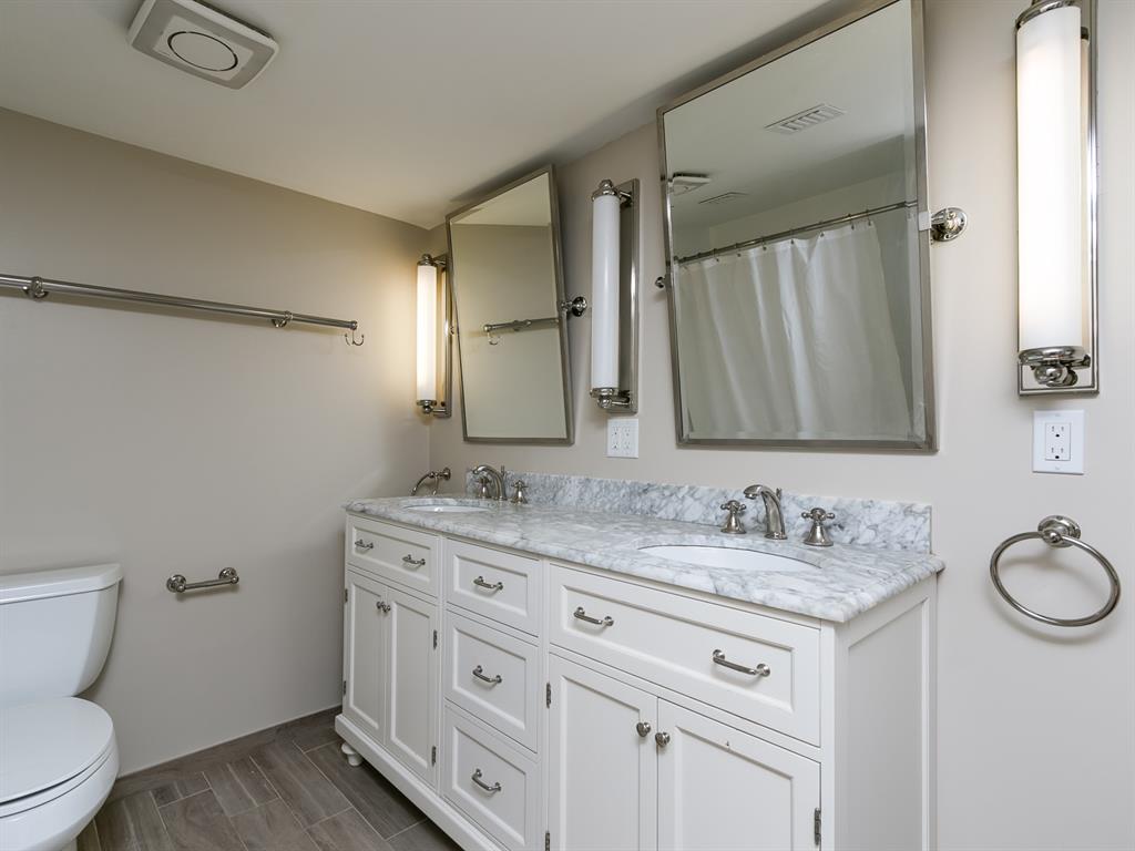 750 North Ocean Boulevard, Unit 210 Pompano Beach, FL 33062 - Photo 9 of 57 a bathroom with a granite countertop sink toilet and a mirror