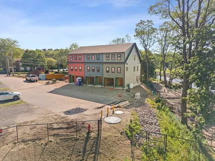 an aerial view of a house with a yard and garden