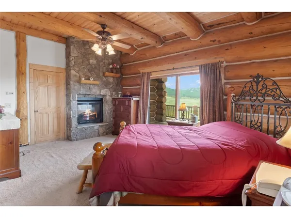 a bedroom with a bed and a fireplace