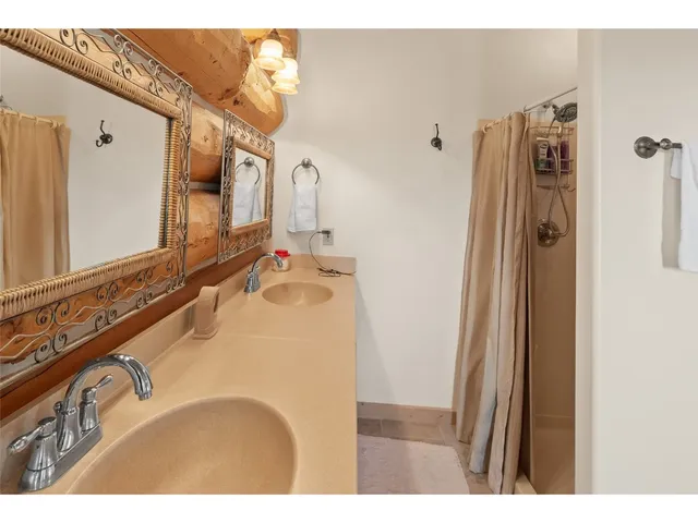 a bathroom with a sink mirror vanity and shower