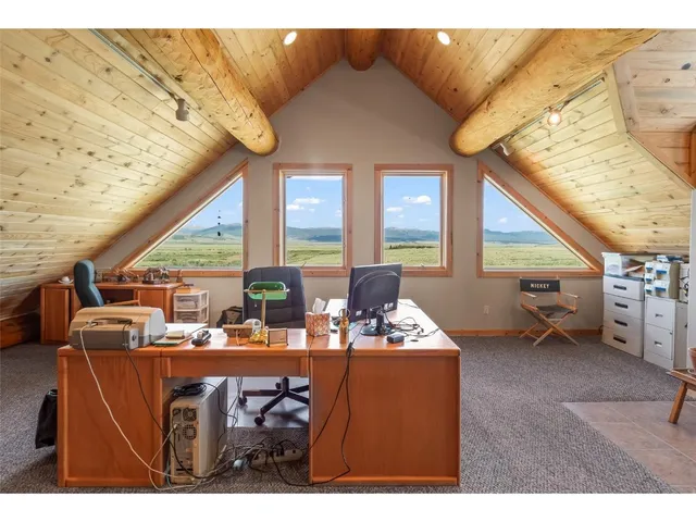 a dining room with furniture and a window