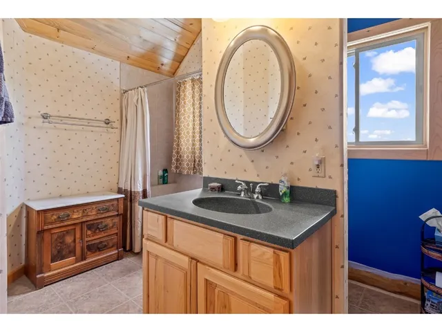 a bathroom with a sink a vanity and a mirror