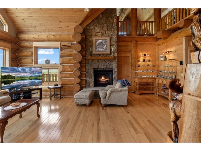 a living room with furniture wooden floor and a fireplace