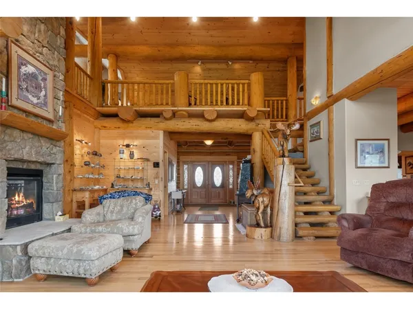 a view of living room with furniture and a fireplace