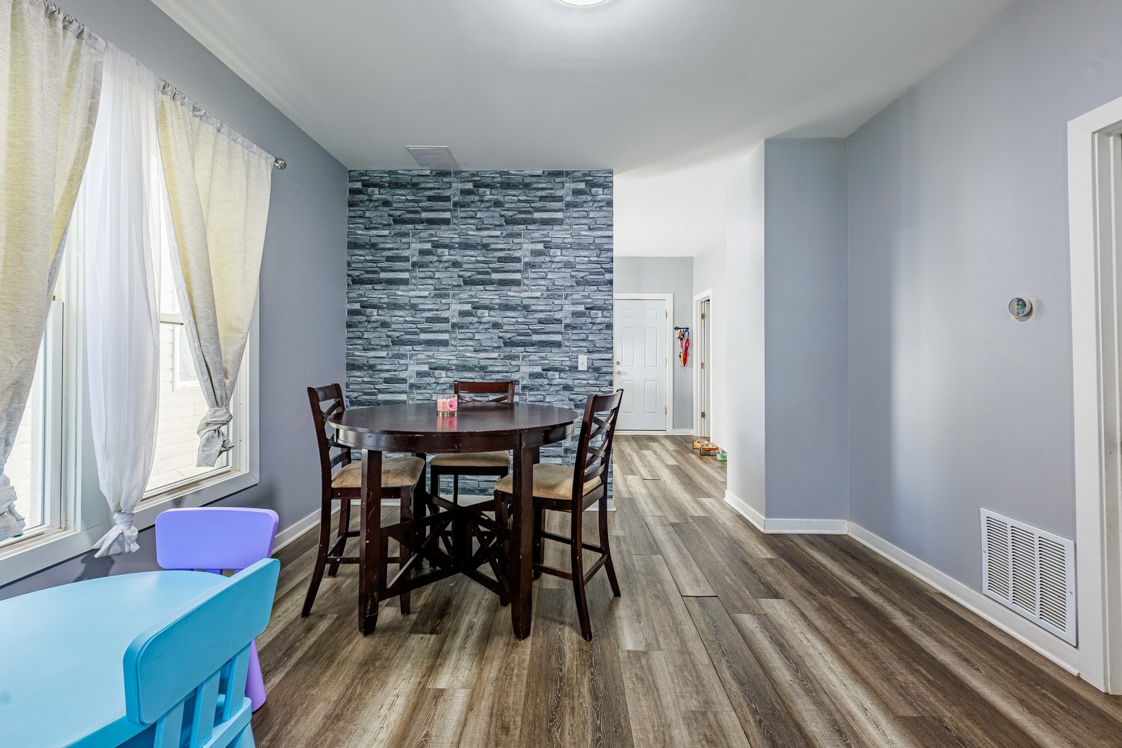 82 Isa Avenue Chicago Heights, IL 60411 - Photo 7 of 16 a view of a dining room with furniture and wooden floor