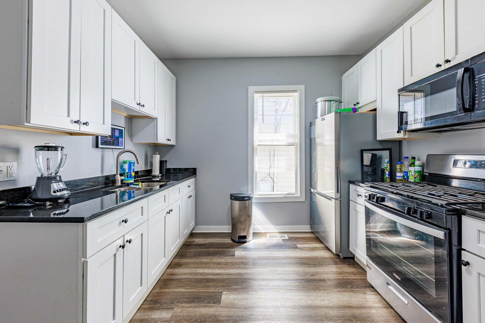 82 Isa Avenue Chicago Heights, IL 60411 - Photo 10 of 16 a kitchen with stainless steel appliances a white stove top oven and a refrigerator
