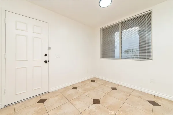 a view of a small space with wooden floor and cabinet