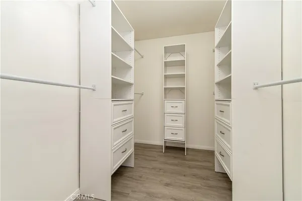a view of walk in closet with empty racks