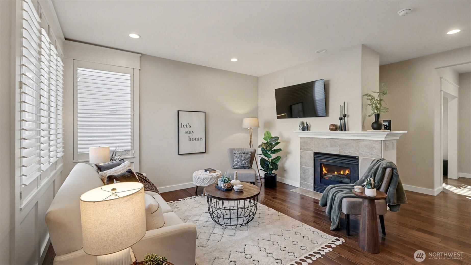 4817 Hartford Way Mukilteo, WA 98275 - Photo 18 of 36 a living room with furniture a flat screen tv and a fireplace