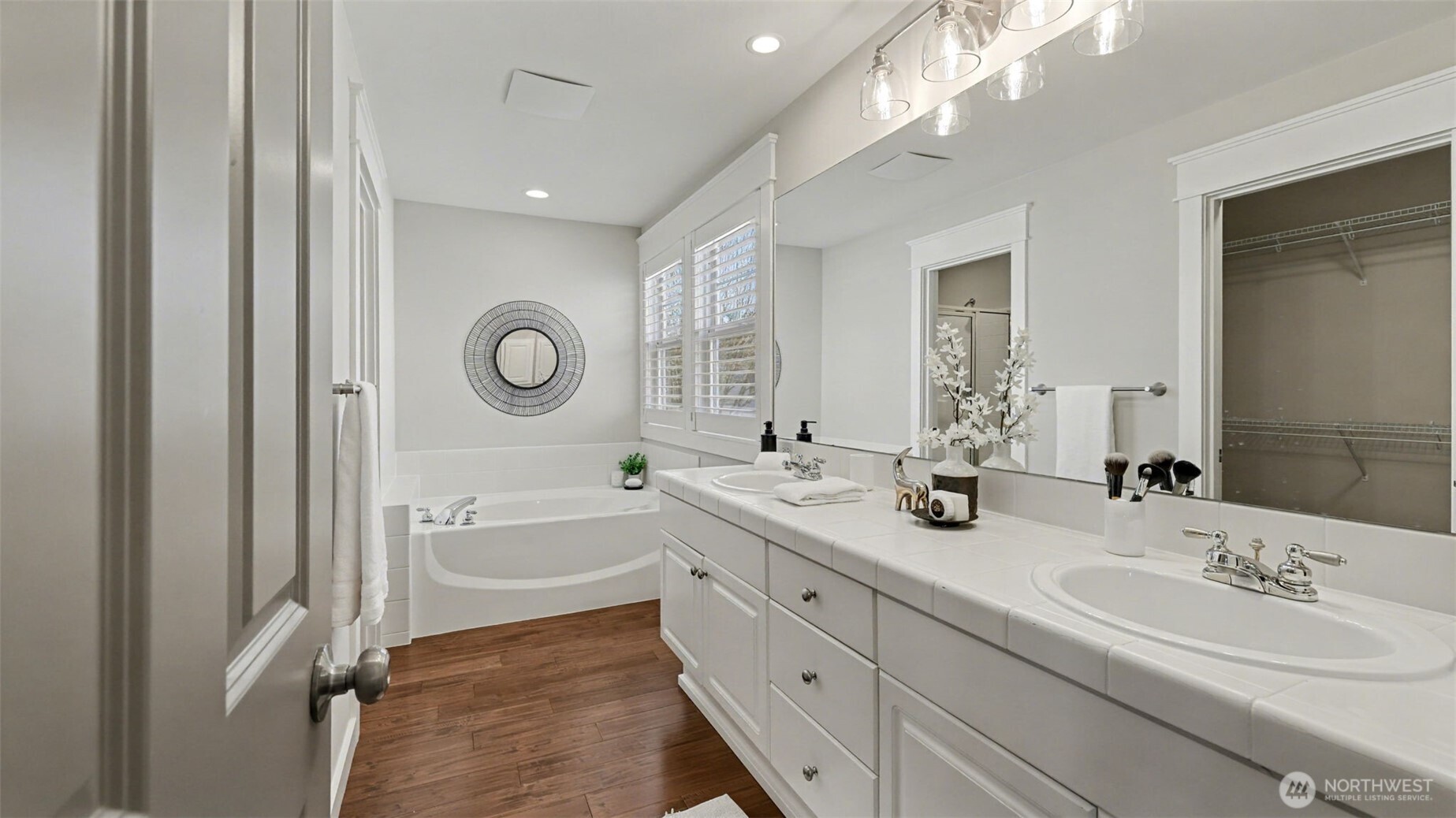 4817 Hartford Way Mukilteo, WA 98275 - Photo 28 of 36 a spacious bathroom with a double vanity sink a mirror and a bathtub