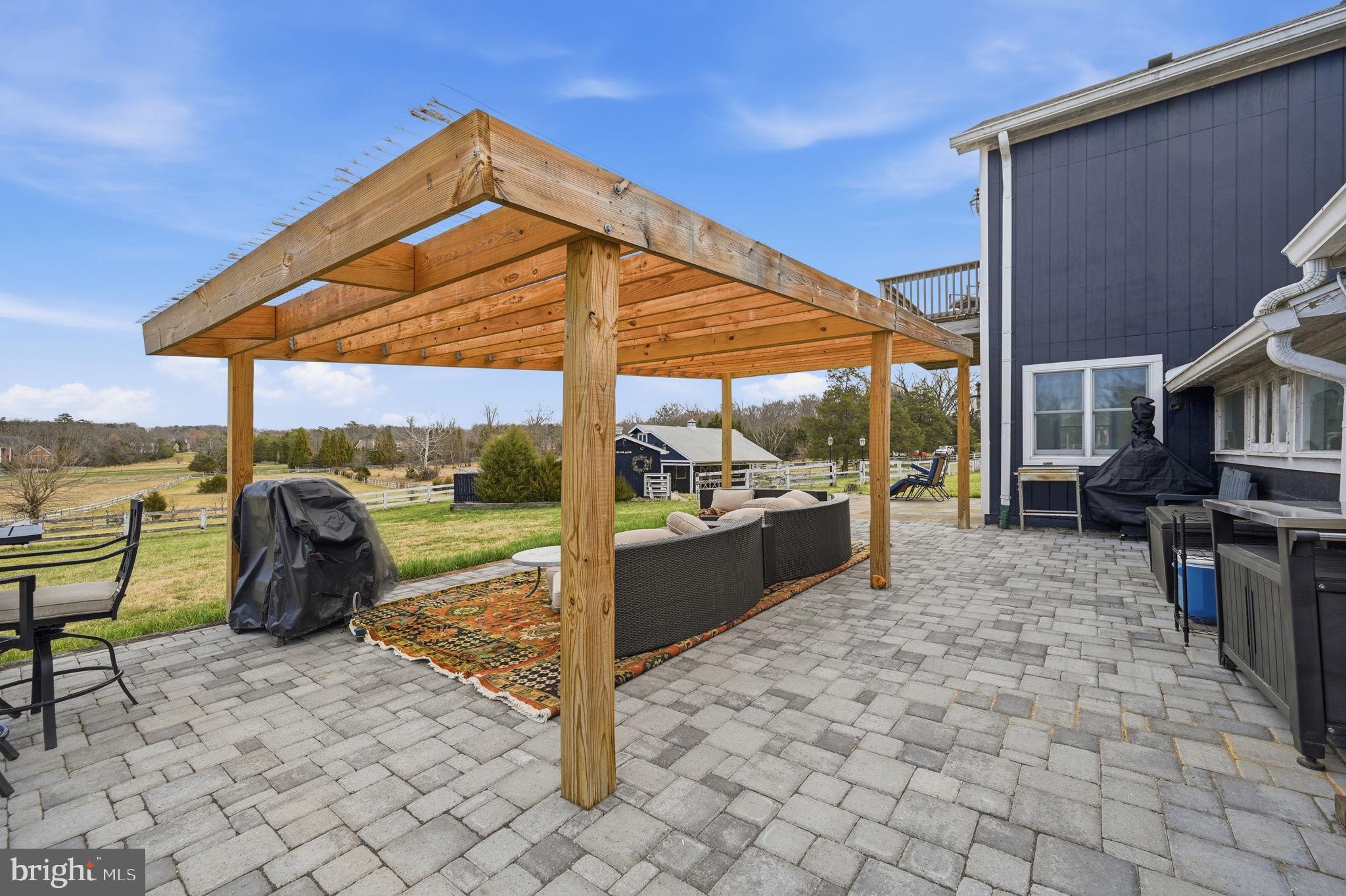 11641 Glen Road Potomac, MD 20854 - Photo 39 of 40 a view of a patio with a table and chairs under an umbrella