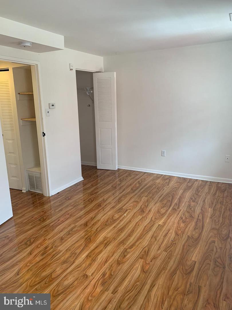 1018 Pine Street, Unit 2F Philadelphia, PA 19107 - Photo 9 of 12 an empty room with wooden floor and entrance