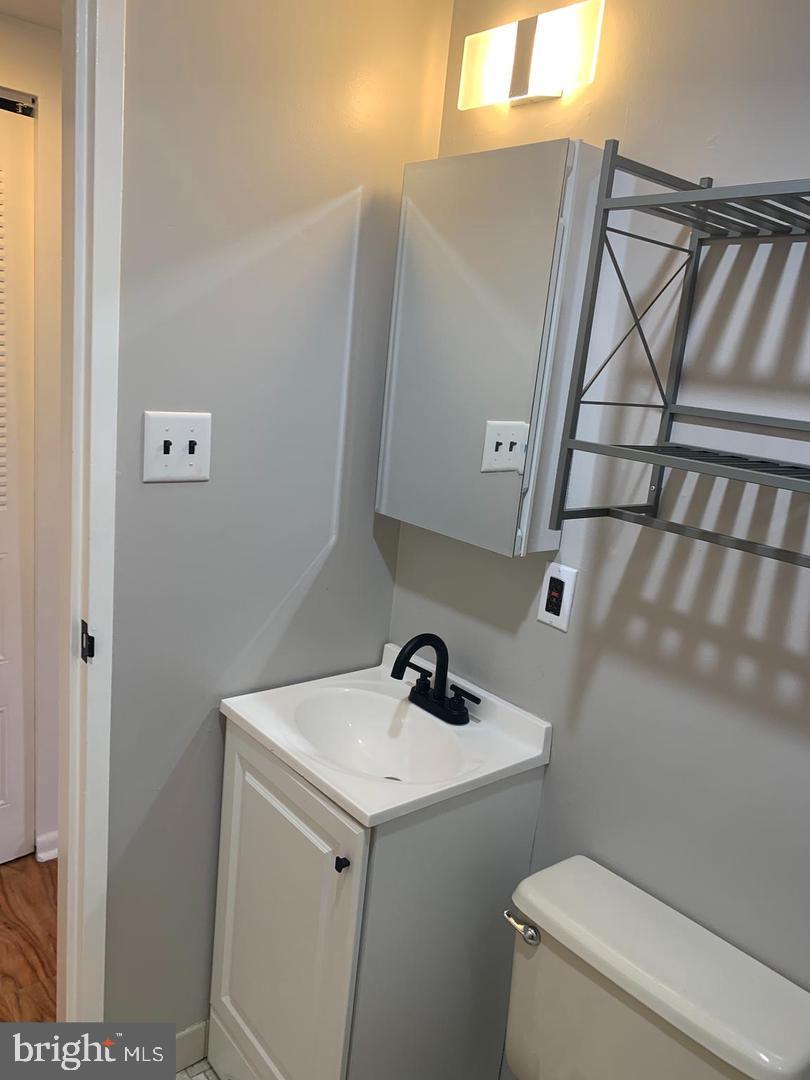 1018 Pine Street, Unit 2F Philadelphia, PA 19107 - Photo 10 of 12 a bathroom with a sink and mirror with toilet