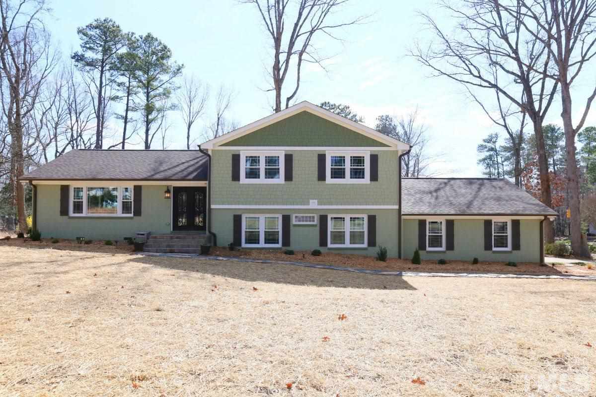 8517 Shadow Wood Place Raleigh, NC 27613 - Photo 1 of 25 a front view of a house with a yard covered in snow