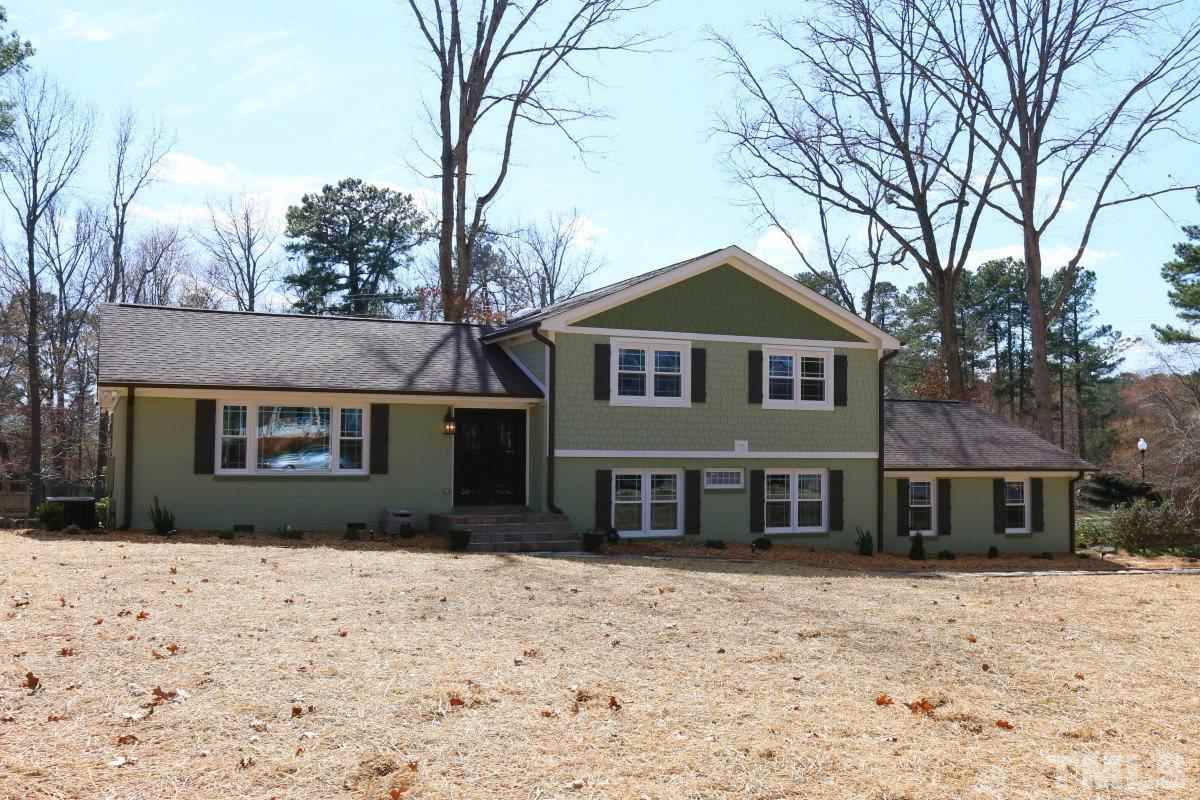 8517 Shadow Wood Place Raleigh, NC 27613 - Photo 2 of 25 a front view of a house with a yard covered in snow