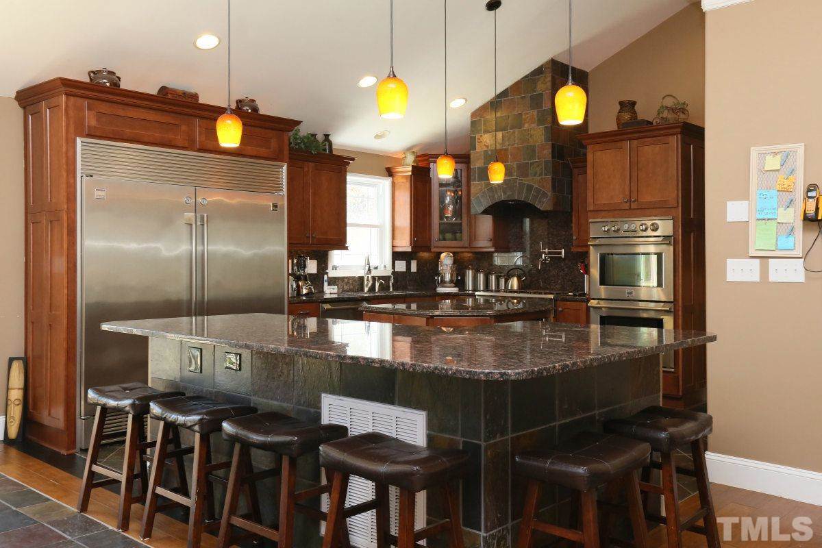 8517 Shadow Wood Place Raleigh, NC 27613 - Photo 11 of 25 a kitchen with a sink cabinets and appliances