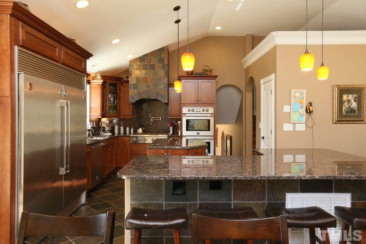 8517 Shadow Wood Place Raleigh, NC 27613 - Photo 12 of 25 a kitchen with a table and chairs in it