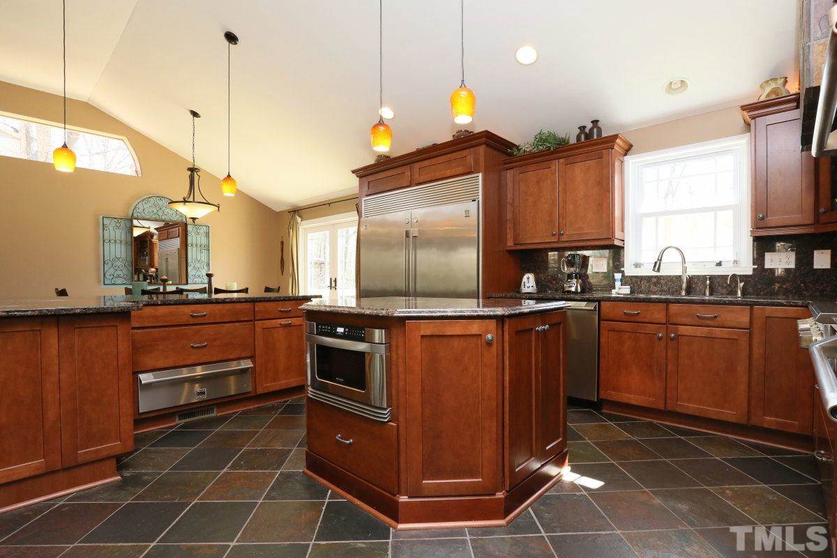 8517 Shadow Wood Place Raleigh, NC 27613 - Photo 13 of 25 a kitchen with stainless steel appliances a sink stove and cabinets