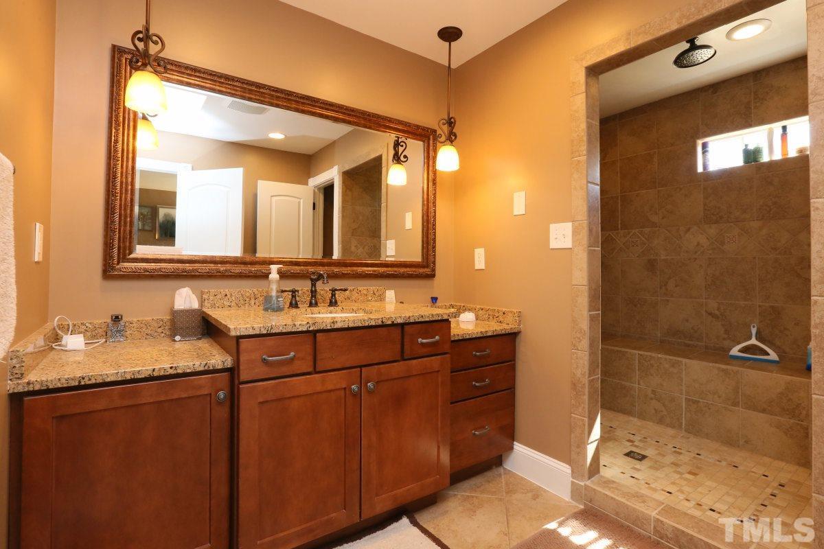 8517 Shadow Wood Place Raleigh, NC 27613 - Photo 17 of 25 a bathroom with a granite countertop sink mirror and double