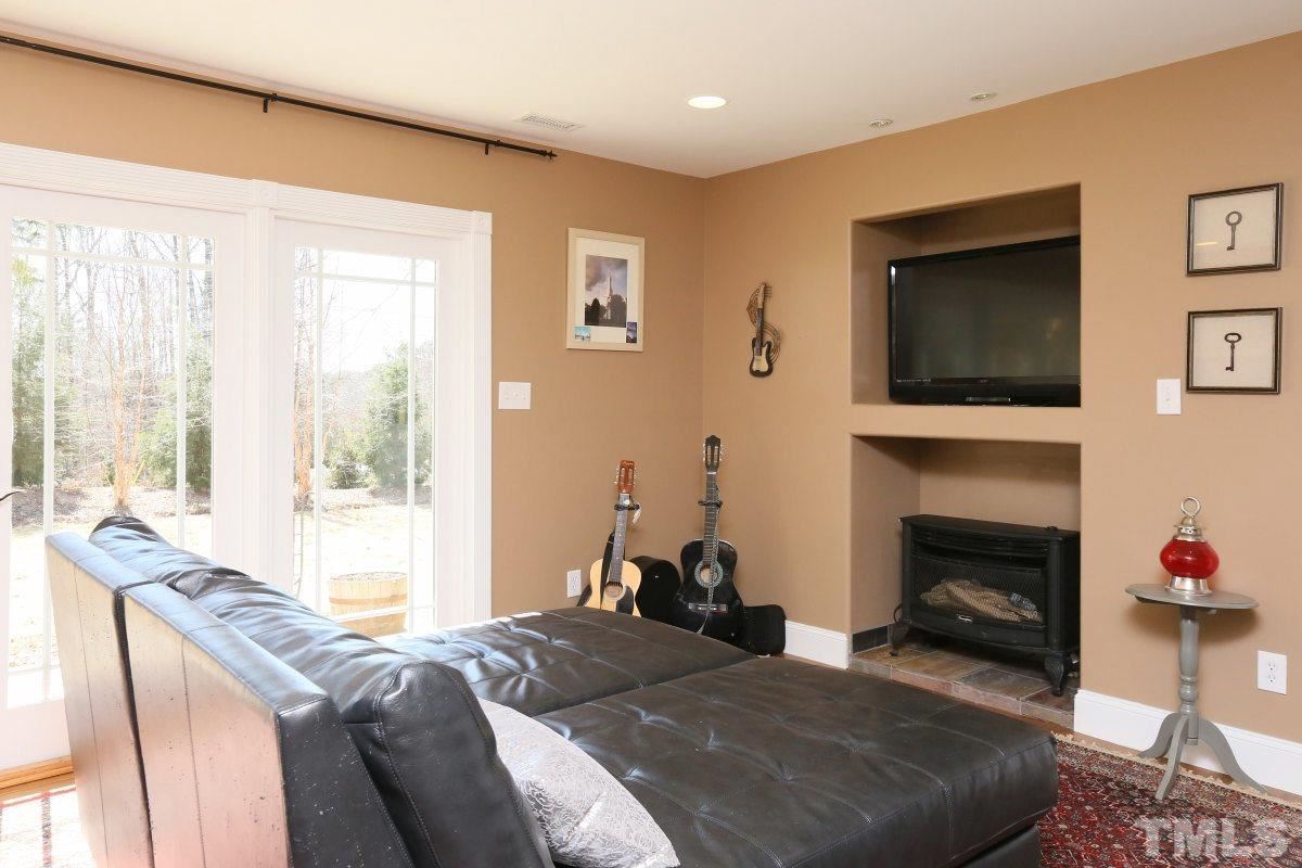 8517 Shadow Wood Place Raleigh, NC 27613 - Photo 7 of 25 a bedroom with a bed and a fireplace