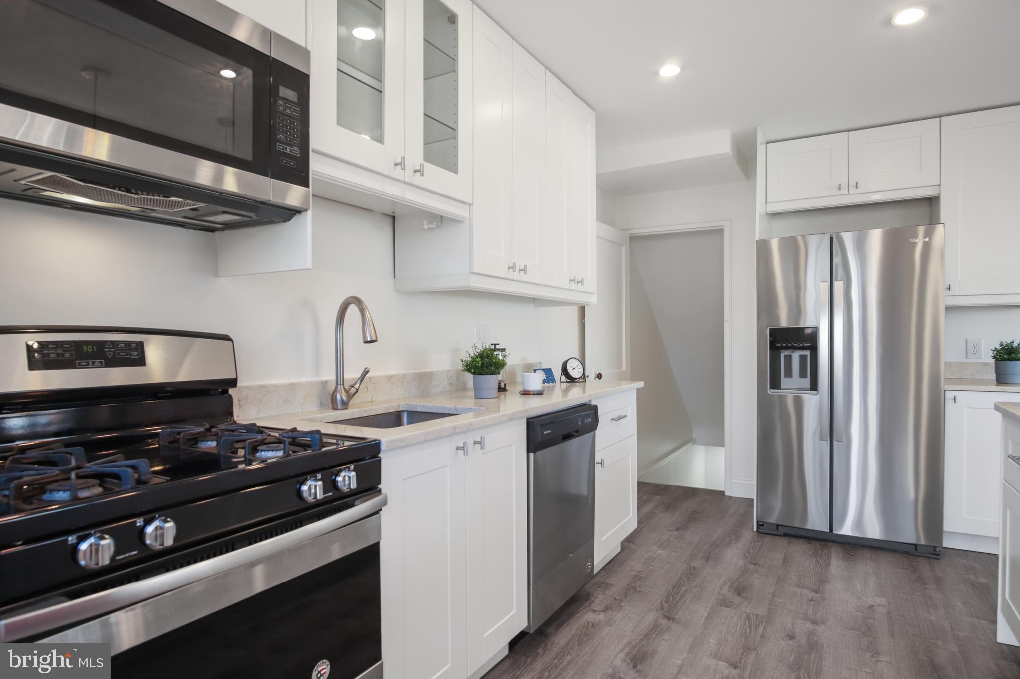 69 Aigburth Avenue Towson, MD 21286 - Photo 11 of 32 a kitchen with stainless steel appliances a sink a stove and a refrigerator