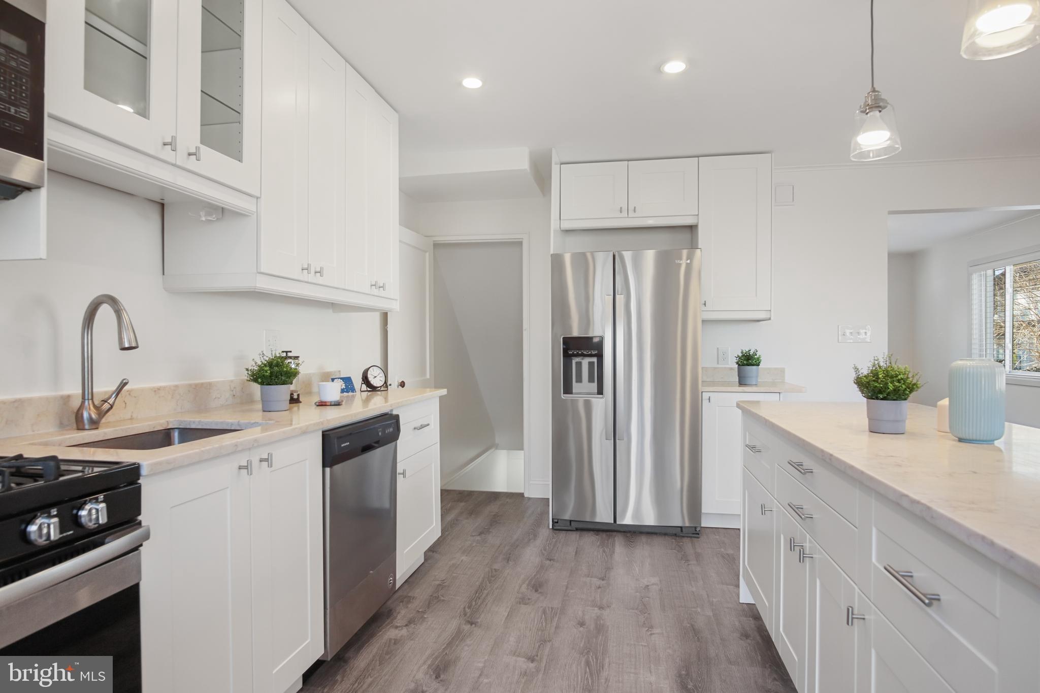 69 Aigburth Avenue Towson, MD 21286 - Photo 12 of 32 a kitchen with a sink white cabinets and stainless steel appliances