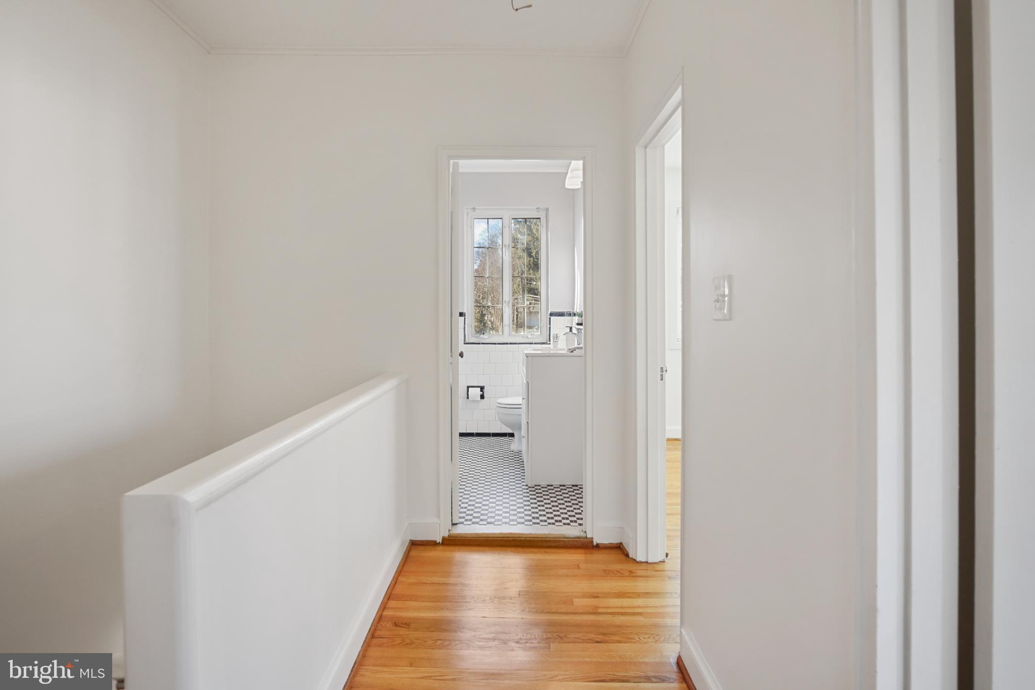 69 Aigburth Avenue Towson, MD 21286 - Photo 13 of 32 a view of a hallway with wooden floor and a bathroom