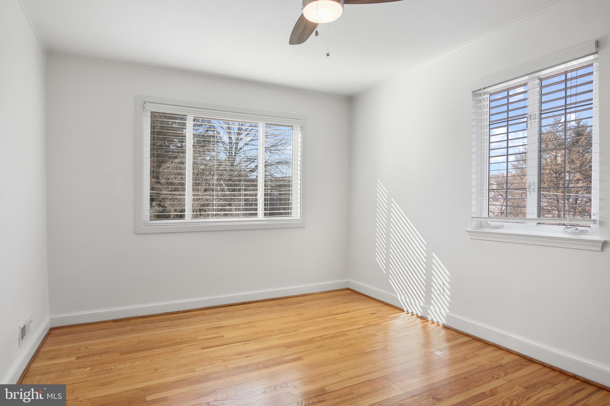 69 Aigburth Avenue Towson, MD 21286 - Photo 16 of 32 a view of an empty room with wooden floor and a window