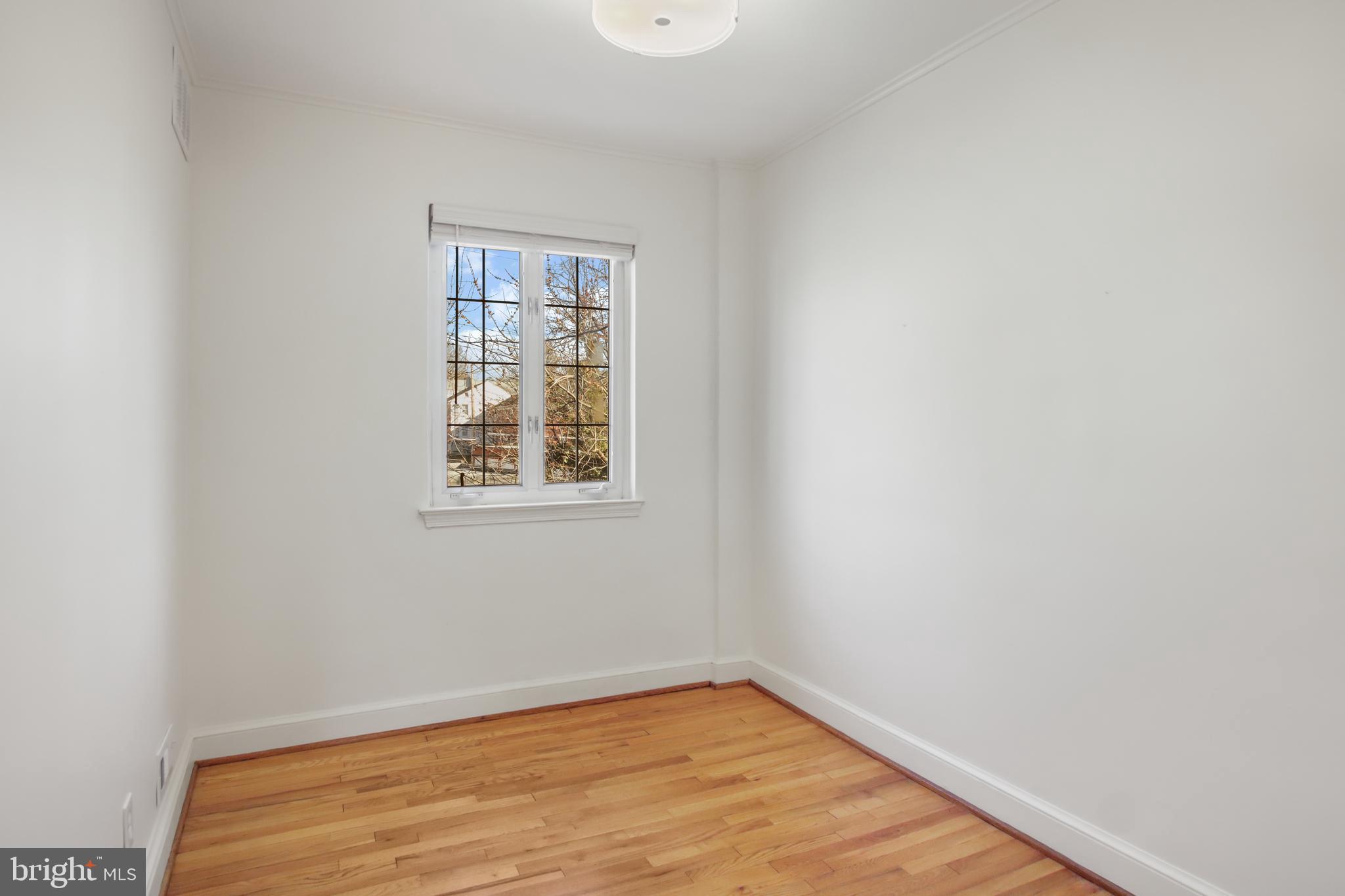 69 Aigburth Avenue Towson, MD 21286 - Photo 21 of 32 a view of an empty room with wooden floor and a window