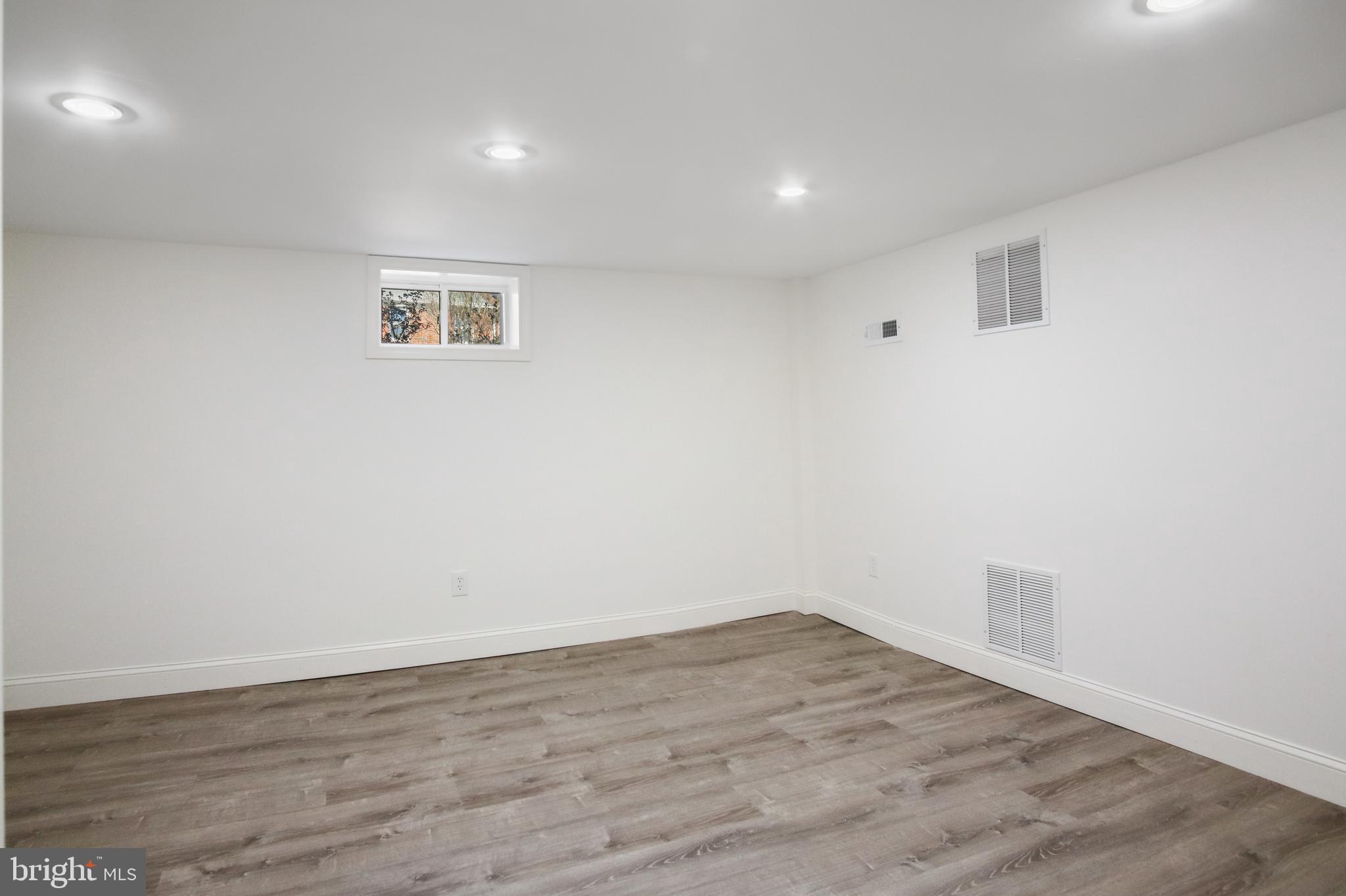 69 Aigburth Avenue Towson, MD 21286 - Photo 24 of 32 a view of a room with wooden floor and white walls