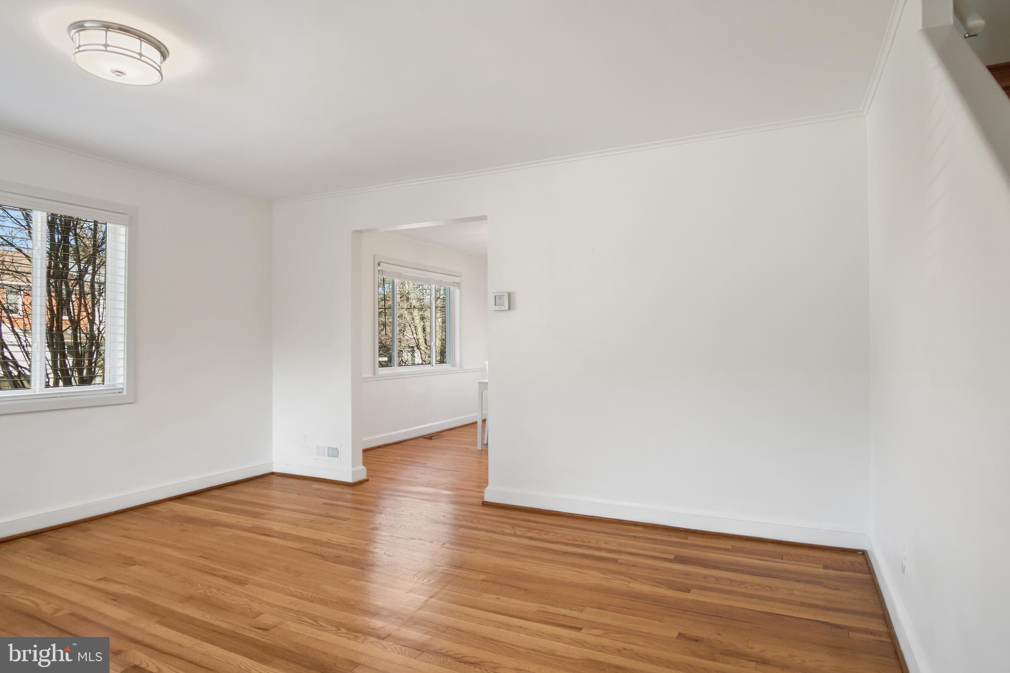 69 Aigburth Avenue Towson, MD 21286 - Photo 4 of 32 a view of an empty room with wooden floor and a window