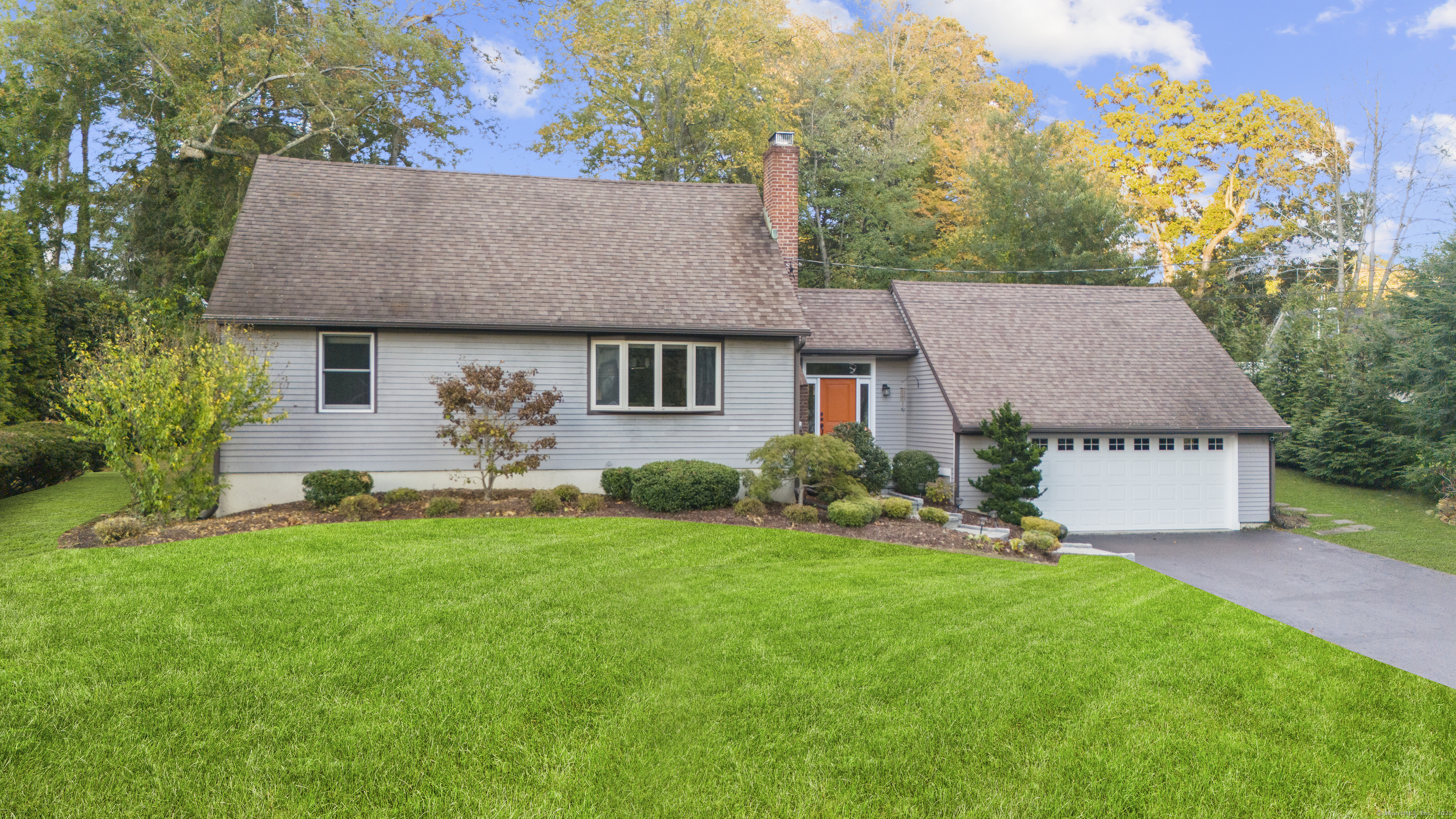 a aerial view of a house with table and chairs in a yard