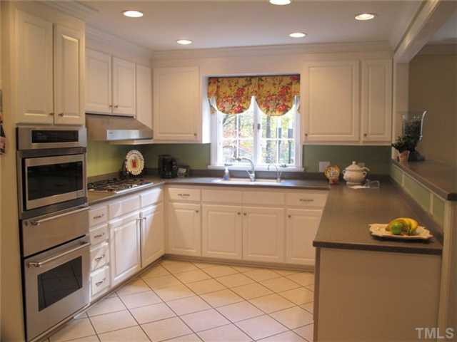 507 Spring Valley Drive Raleigh, NC 27609 - Photo 13 of 25 Kitchen features Corian counters with breakfast bar and stainless Thermador appliances..