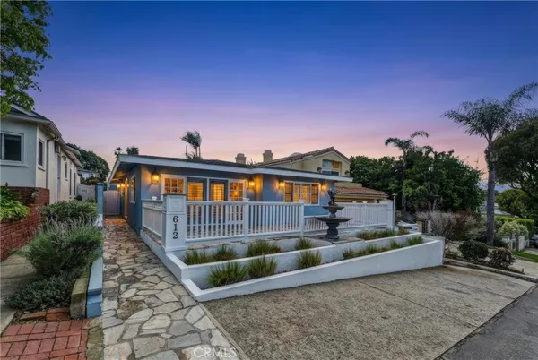 a view of a house with wooden fence