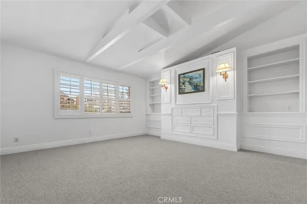 a kitchen with a stove and white cabinets