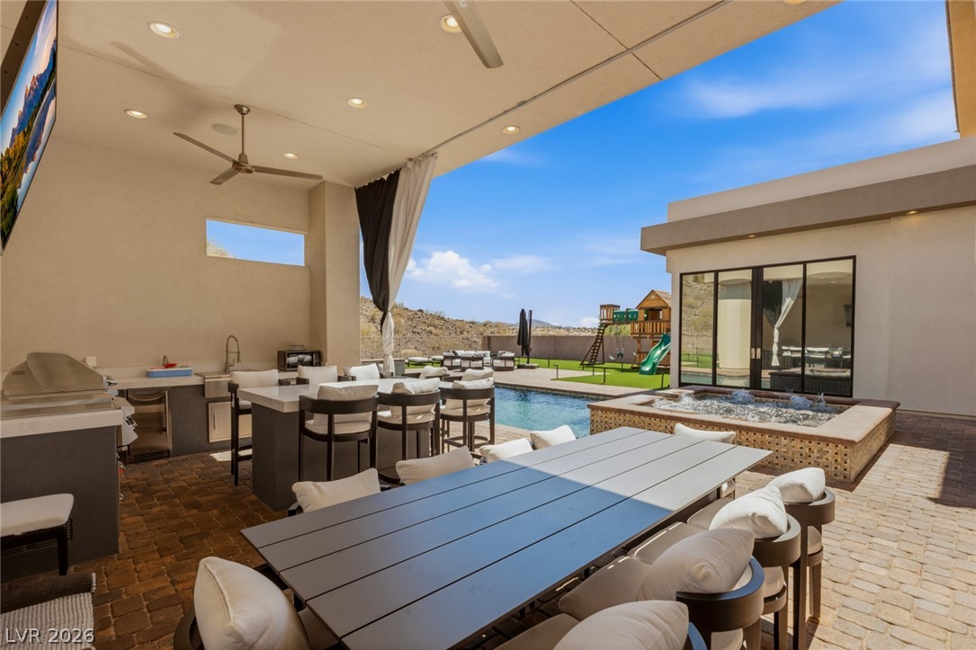 5 Crystal Tree Pass Henderson, NV 89052 - Photo 41 of 67 An inviting outdoor living space features a covered patio, complete with a dining area and a sparkling pool.