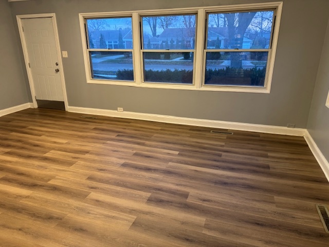 7100 Wilson Terrace Morton Grove, IL 60053 - Photo 4 of 15 a view of a room with wooden floor and windows
