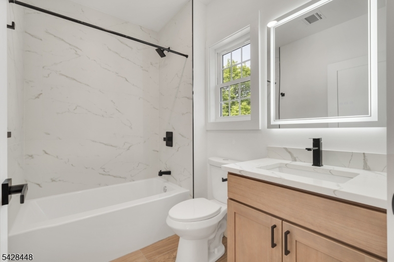 196 Taylor Street Orange, NJ 07050 - Photo 11 of 31 a bathroom with a sink toilet and shower