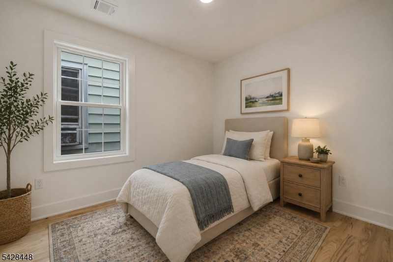 196 Taylor Street Orange, NJ 07050 - Photo 16 of 31 a bedroom with a bed and a window