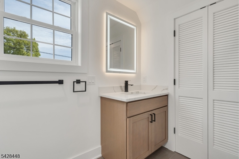 196 Taylor Street Orange, NJ 07050 - Photo 22 of 31 a bathroom with a sink cabinet and a window