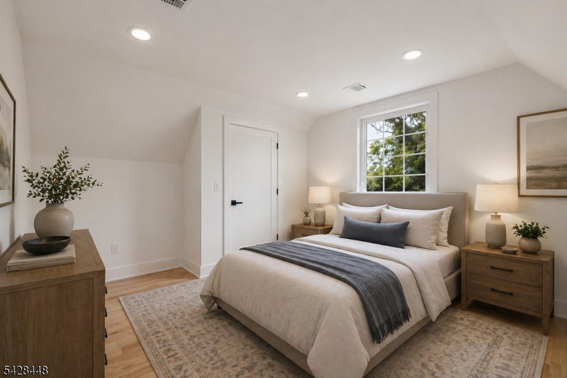 196 Taylor Street Orange, NJ 07050 - Photo 25 of 31 a bedroom with a bed and a potted plant