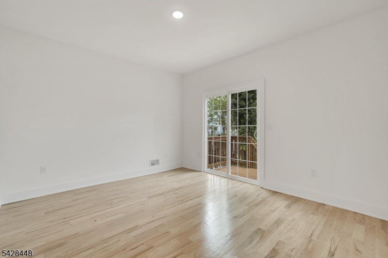 196 Taylor Street Orange, NJ 07050 - Photo 6 of 31 an empty room with wooden floor and windows