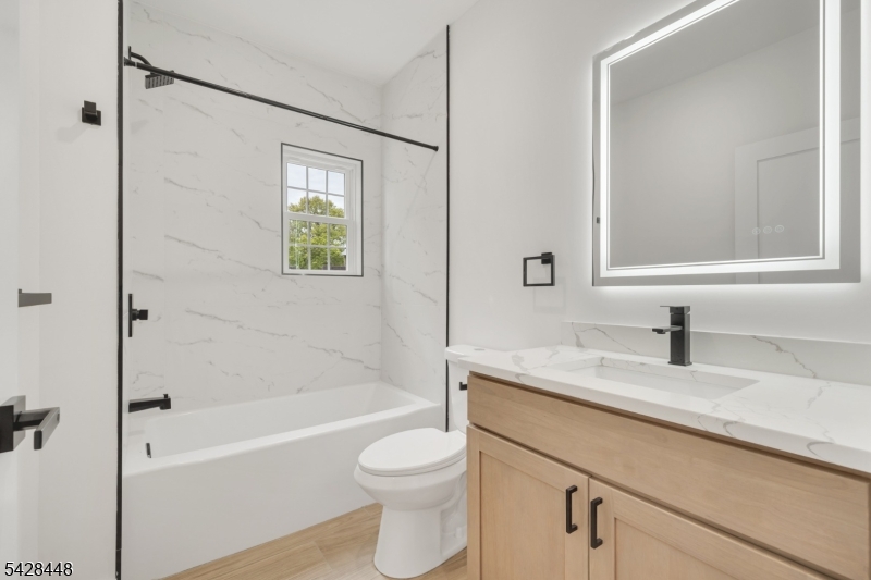 196 Taylor Street Orange, NJ 07050 - Photo 7 of 31 a bathroom with a granite countertop sink toilet and shower