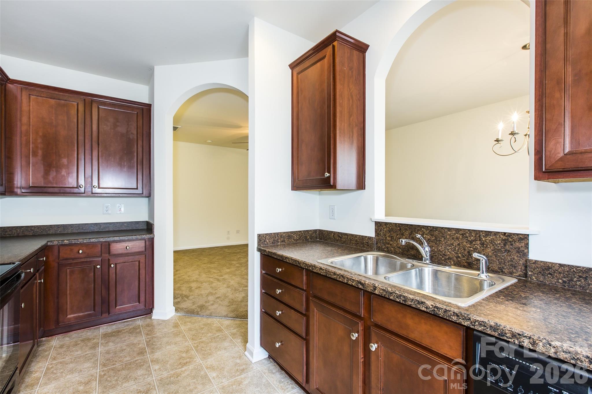 13422 Erwin Road Charlotte, NC 28273 - Photo 15 of 35 a kitchen with granite countertop a sink and cabinets