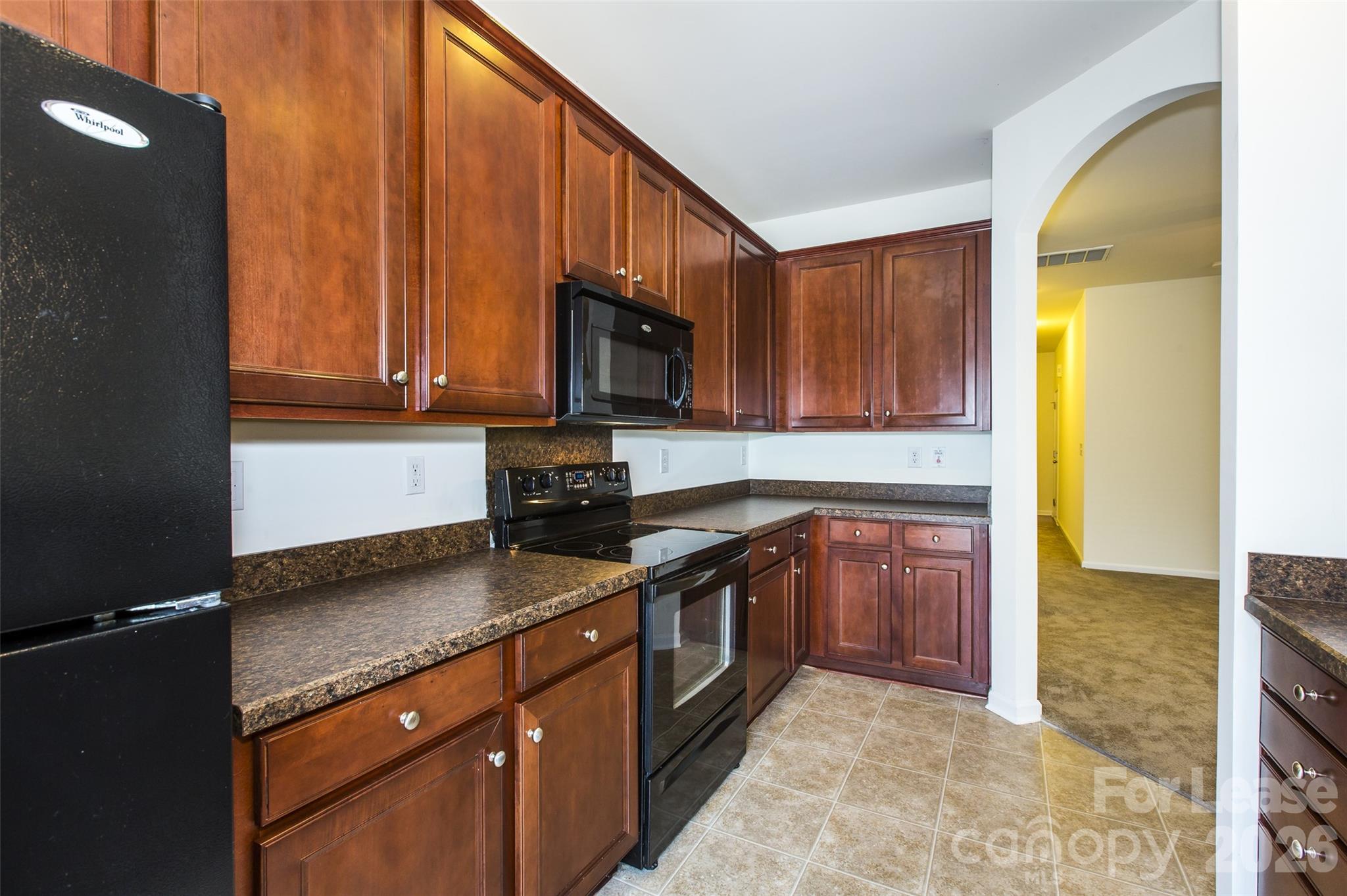 13422 Erwin Road Charlotte, NC 28273 - Photo 16 of 35 a kitchen with stainless steel appliances granite countertop a sink a stove cabinets and a kitchen island