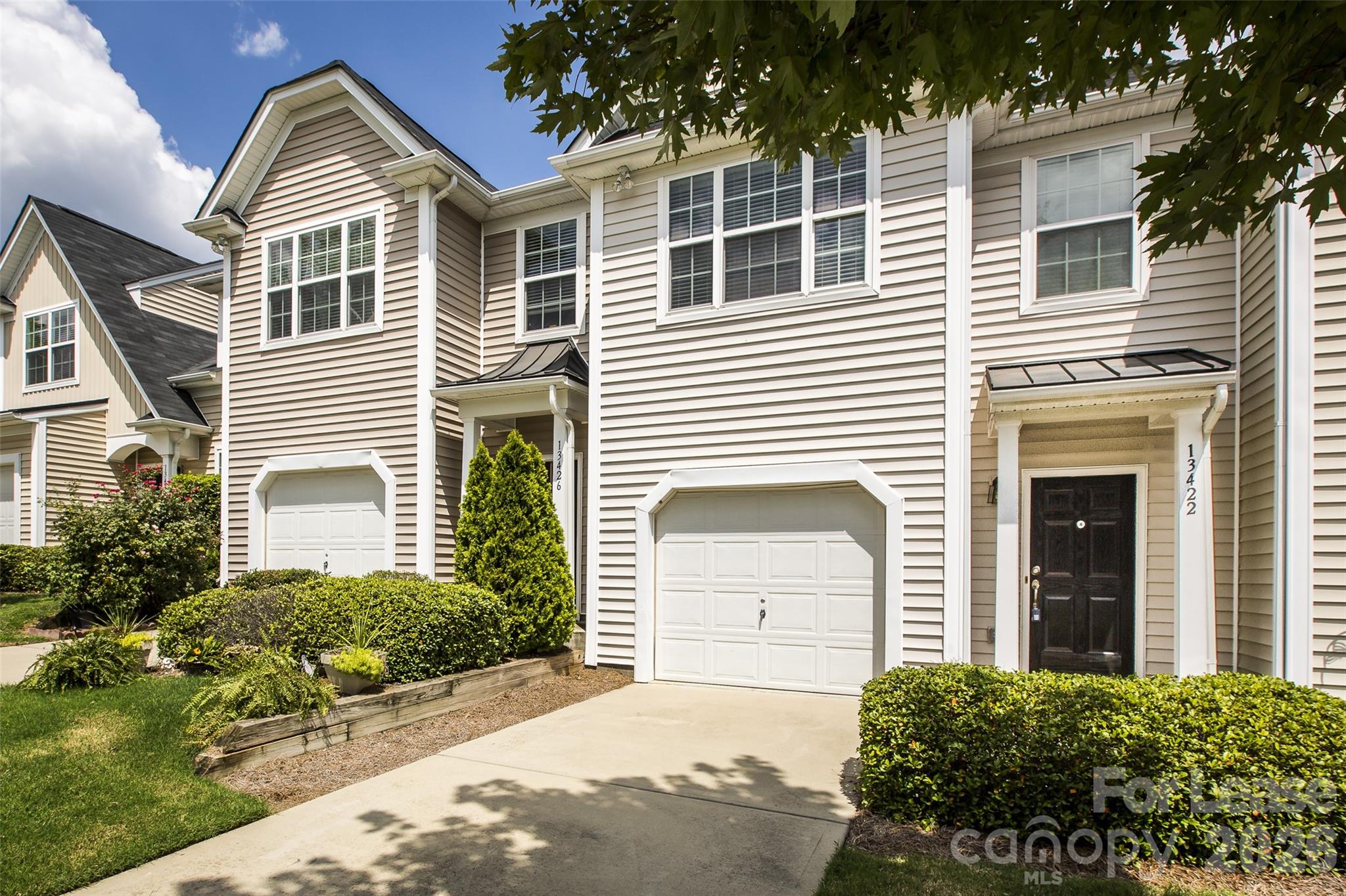 13422 Erwin Road Charlotte, NC 28273 - Photo 2 of 35 a front view of a house with a yard and garage
